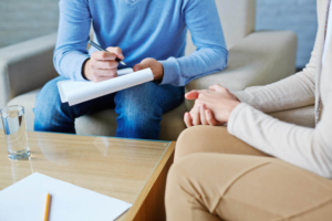 Photo of somone speaking with a therapist representing how depression therapy in Atlanta, GA can be beenficial in providing you support and managing your symtpoms.
