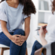 Photo of an African American woman sitting down and speaking with another woman. Are you facing anxiety symptoms but not sure if you should get help? With anxiety therapy in Atlanta, GA you can begin working on overcoming your symptoms with an anxiety therapist.