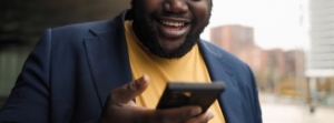 Photo of a smiling man talking to someone through his cell phone. With stress therapy in Atlanta, GA you can become motivated and stress-free when working from home. Find support with a skilled therapist today.