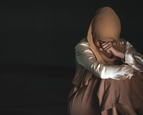 Photo of a Muslim woman sitting on the ground covering her face. Are you struggling to manage the grief of the loss of a loved one? Discover how grief counseling in Atlanta, GA can help you begin to manage your symptoms in a healthy way.