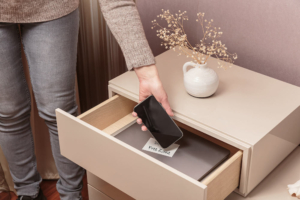 Photo of a woman sitting her phone in a drawer. Discover tips on alleviating your depression symptoms in depression therapy in Atlanta, GA.