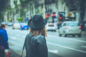 Photo of a woman standing on the sidewalk looking at the traffic on the street. Intrusive thoughts can be overwhelming when not managed. Discover how anxiety therapy in Atlanta, GA can help you begin coping with your thoughts.