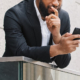 Photo of an anxious man looking at his phone. Learn to manage life transitions more effectively with the help of anxiety therapy in Atlanta, GA.