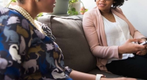Photo of two women sitting on a couch talking. Discover how depression therapy in Atlanta, GA can help you work through your symptoms and overcome your depression in a healthy way.