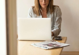 Photo of a professional woman working on a laptop. Learn how to overcome your perfectionism anxiety with the help of anxiety therapy in Atlanta, GA.
