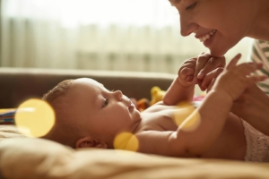 A close up of a mother smiling at her newborn baby. This could symbolize the love felt for baby after postpartum therapy in Atlanta, GA. Search for therapy for anxiety in Atlanta, GA to get in contact with a postpartum therapist in Atlanta, GA today for support. 