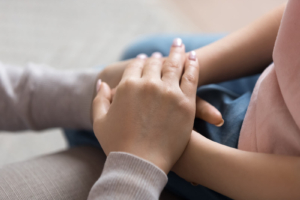 A close up of a person offering a supportive hand which represents the support birth trauma therapy in Atlanta, GA can offer. Learn how a postpartum therapist in Atlanta, GA can offer support by searching for therapy for birth trauma in Atlanta, GA today. 