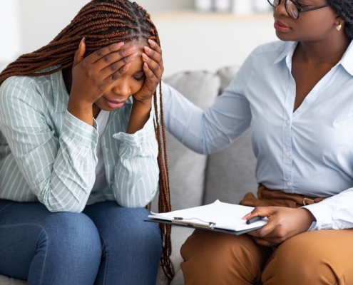 A woman offers a hand in support for a woman with a stressed expression. Learn how a depression therapist in Atlanta, GA can offer support with addressing mental health concerns. Search for online depression therapy in Atlanta, GA and how a psypact therapist in Atlanta, GA can help.