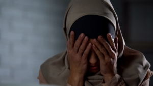 A close up of a woman covering her face representing the pain of past depression and sadness. Learn how a depression therapist in Atlanta, GA can offer support in coping with a depressive episode in Atlanta, GA. Search for online depression therapy in Atlanta, GA to learn more. 