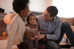 Image of a happy family smiling. Strengthen your bond with your baby and partner while overcoming postpartum anxiety and depression. Get the support you need through postpartum counseling in Atlanta, GA. 