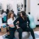 A postpartum therapist in Atlanta, GA helps a pregnant woman with gentle core exercises on a stability ball, supporting her through postpartum therapy in Atlanta, GA and offering care that complements postpartum anxiety treatment in Atlanta.