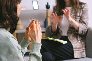 A close-up of a therapist and client in an emotional therapy session, highlighting the supportive role of a perinatal therapist in Atlanta, GA offering pregnancy therapy in Atlanta, GA and alpharetta postpartum anxiety treatment for those coping with loss and anxiety. 