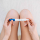 A woman holds a positive pregnancy test, reflecting mixed emotions of hope and fear while seeking postpartum therapy in Atlanta, GA, postpartum counseling Atlanta, postpartum anxiety treatment Atlanta, and Alpharetta postpartum anxiety treatment.