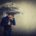 A man stands under a storm cloud, holding an umbrella as rain pours—capturing the heaviness of loss and worry. Support like grief counseling in atlanta, ga with a compassionate grief therapist in atlanta, ga can also include therapy for anxiety in atlanta, ga to ease the pressure.